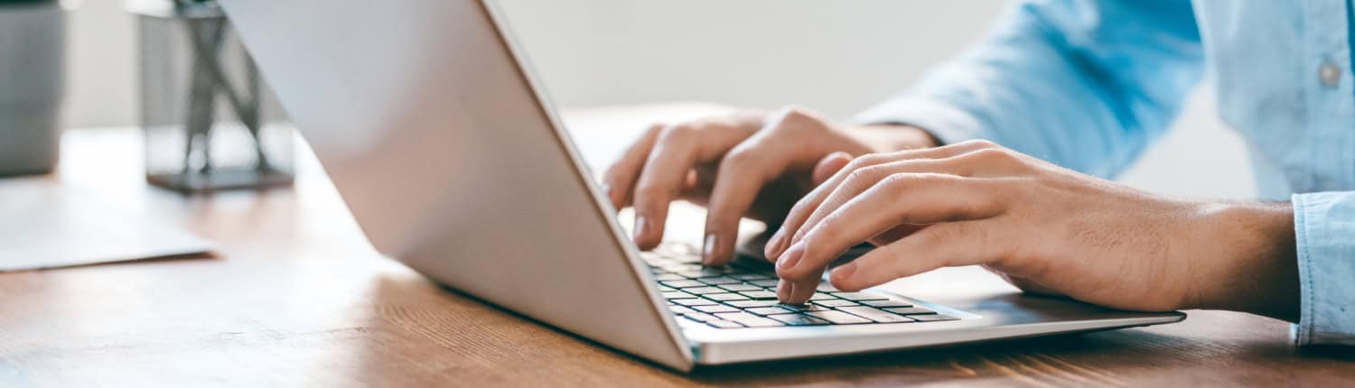 Hands of young contemporary office manager over laptop keypad during work
